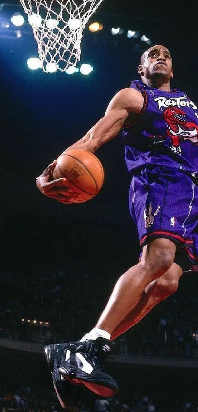 Basketball player executing high slam dunk in purple jersey.