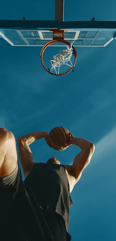 Basketball player performing a dunk under a blue sky.