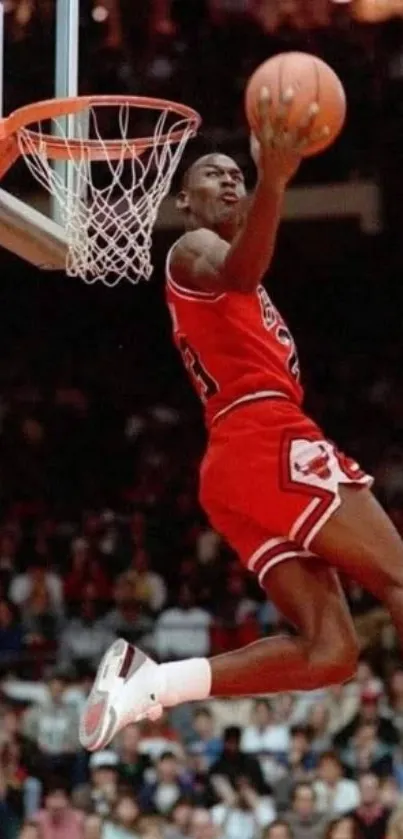 Iconic basketball player performing a slam dunk in red uniform.