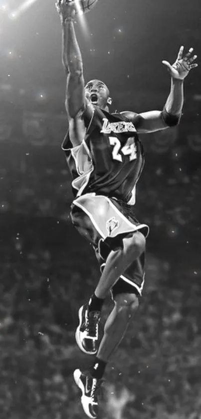 Monochrome image of a basketball player leaping mid-air.