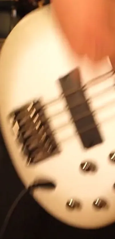 Close-up of a white bass guitar with dynamic lighting.