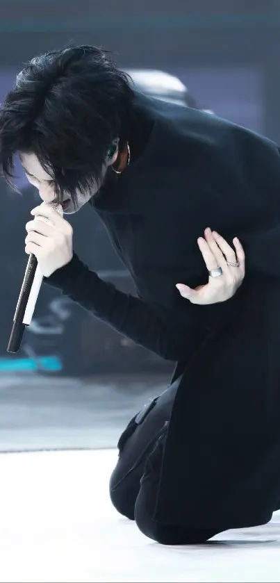 Singer in dynamic black-and-white performance on stage.