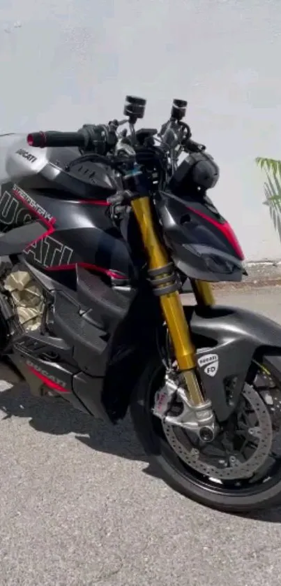 Sleek black motorcycle with gold forks parked outdoors.