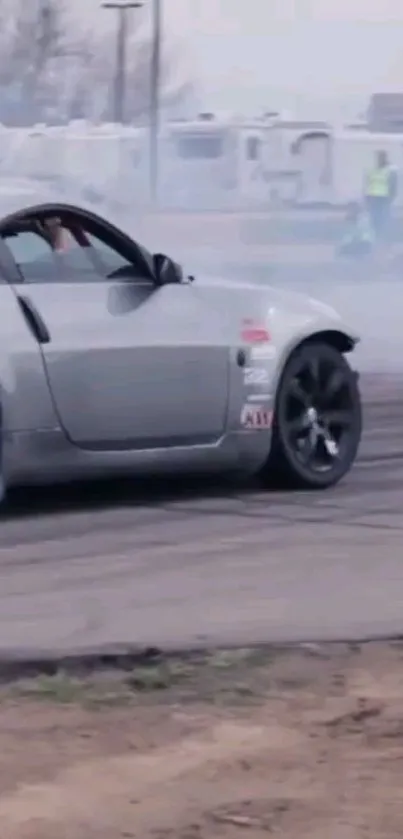 Car drifting with smoke on a track.