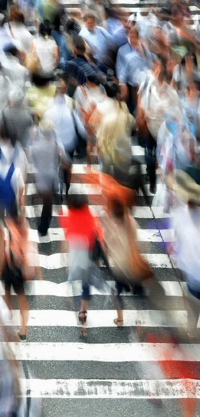 Blurry urban crosswalk with bustling pedestrians in motion.