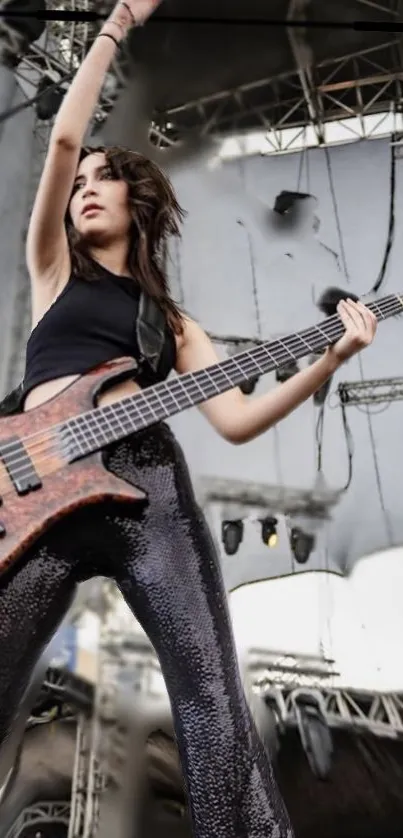 Bassist performing energetically on stage in live concert.