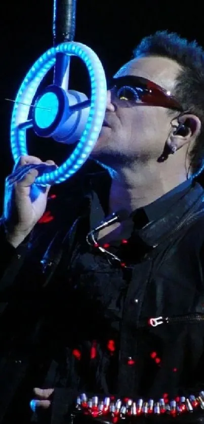 Concert wallpaper featuring a performer with vibrant blue lights.