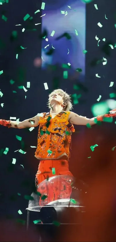 Performer on stage with green confetti in vibrant concert scene.