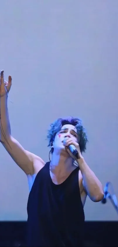 Performer passionately singing under blue stage lights.