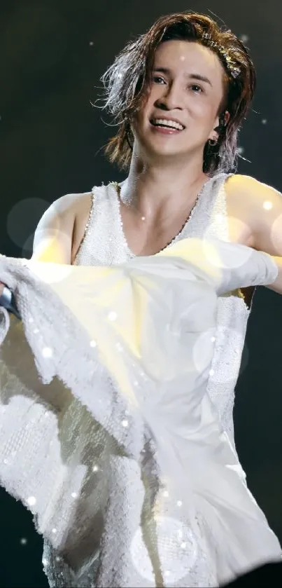 Energetic performer in white during concert.