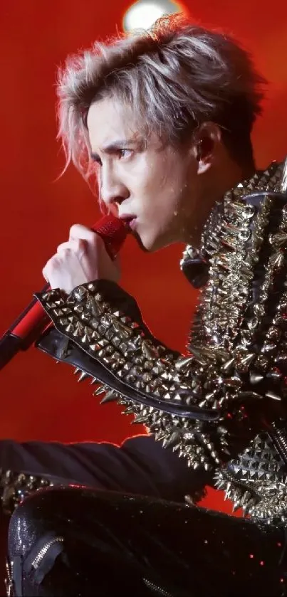 Charismatic stage performer in striking red ambiance.