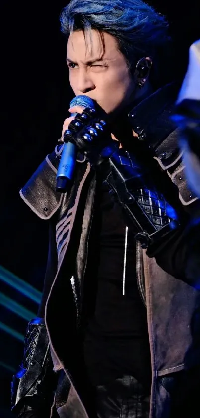 Charismatic performer in dark blue lighting with microphone on stage.