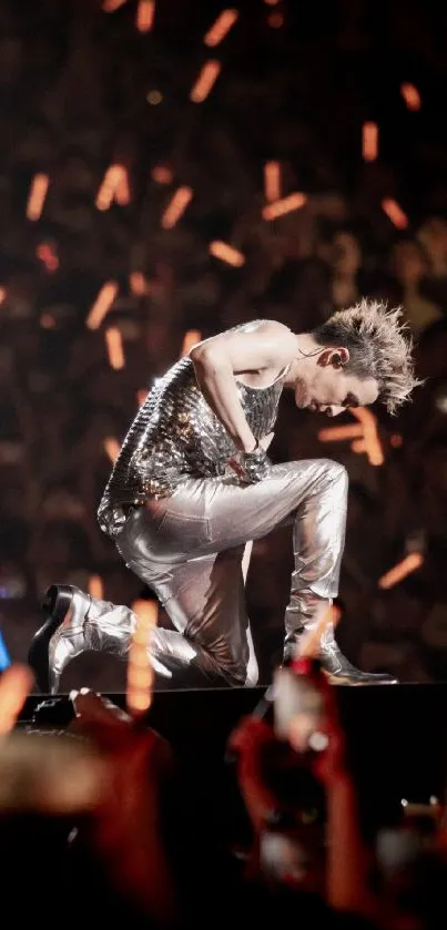 Kneeled performer on a vibrant lit stage.