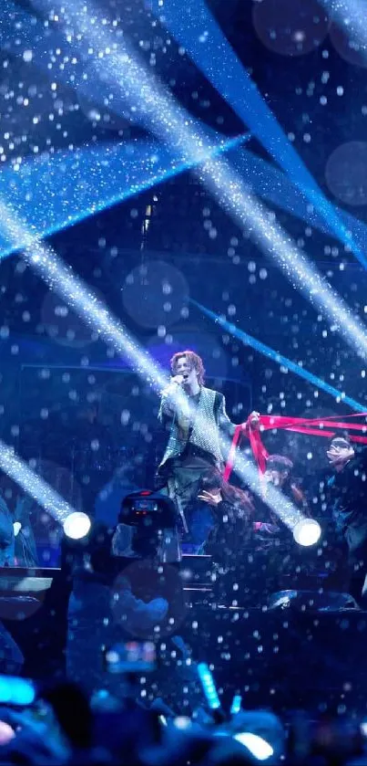 Energetic concert scene with vibrant blue lights and performers on stage.