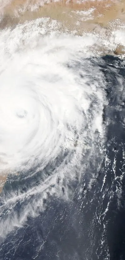 Dynamic cyclone storm with swirling clouds viewed from above.