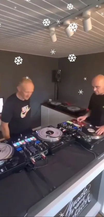 DJ duo performing with vinyl records and snowflake decorations.