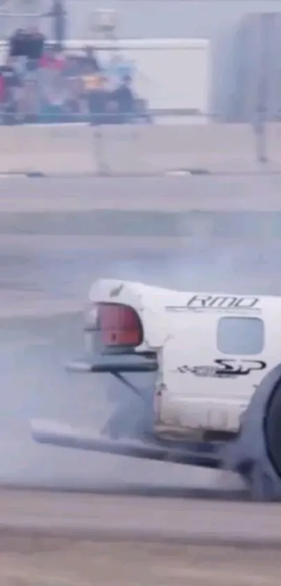 Drift car leaving a trail of smoke on a racing track.