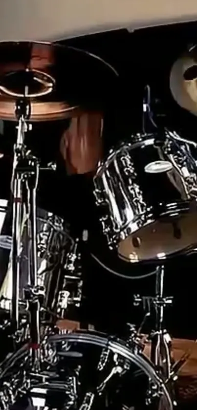 Silver drum set on stage with dark background.