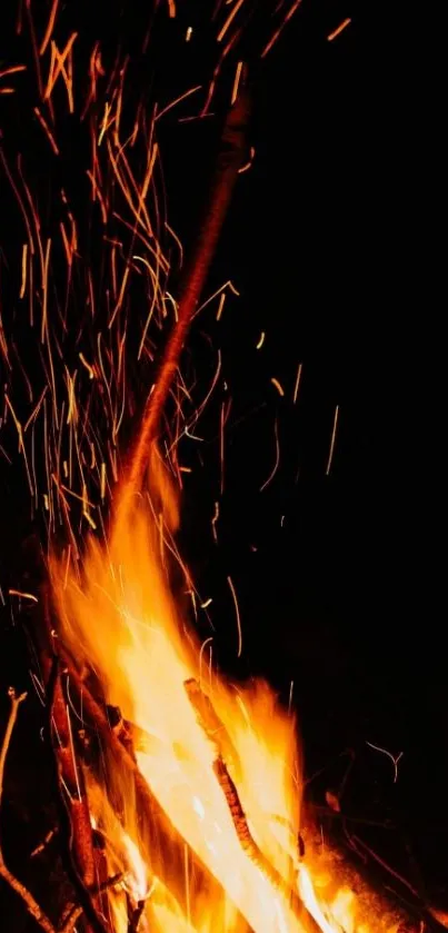 Engaging mobile wallpaper of fire with vibrant sparks and deep dark background.