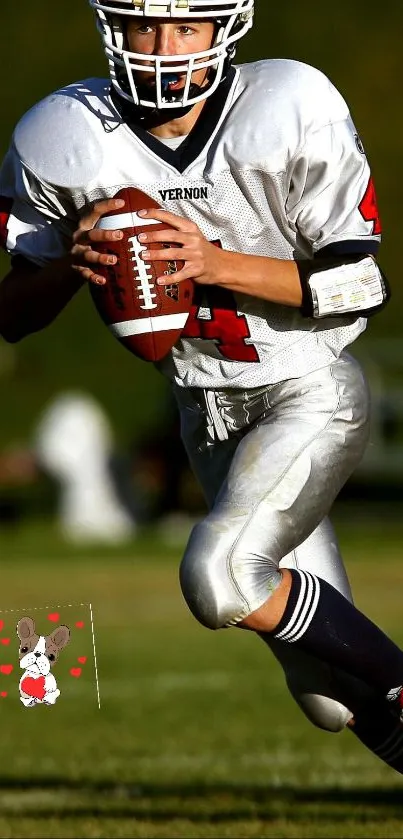 Young football player running with the ball on a field.