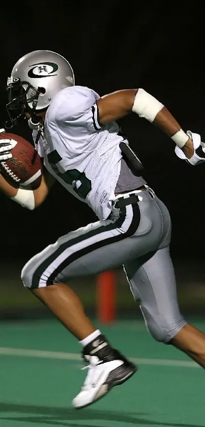 Football player in action on field at night.