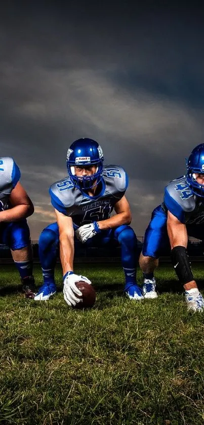 Five football players ready for action on the field at night.