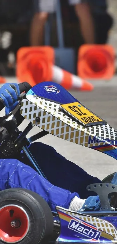 Go-kart racer in dynamic motion on track, wearing blue gear.