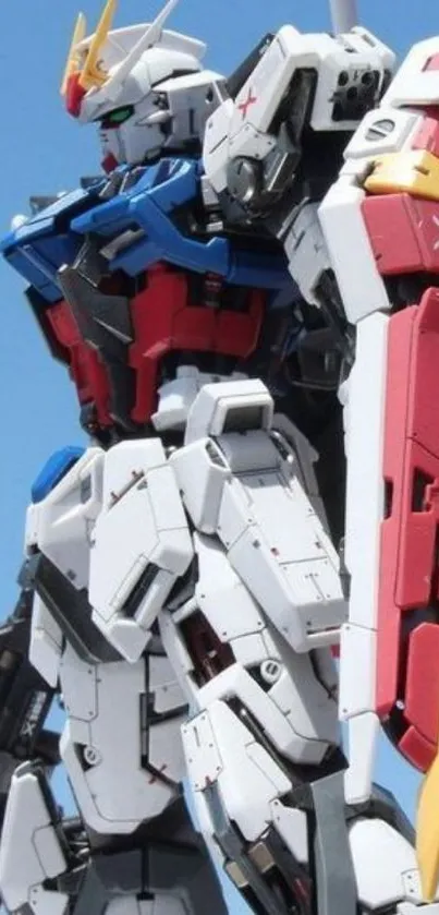 Gundam robot in dynamic pose against blue sky.