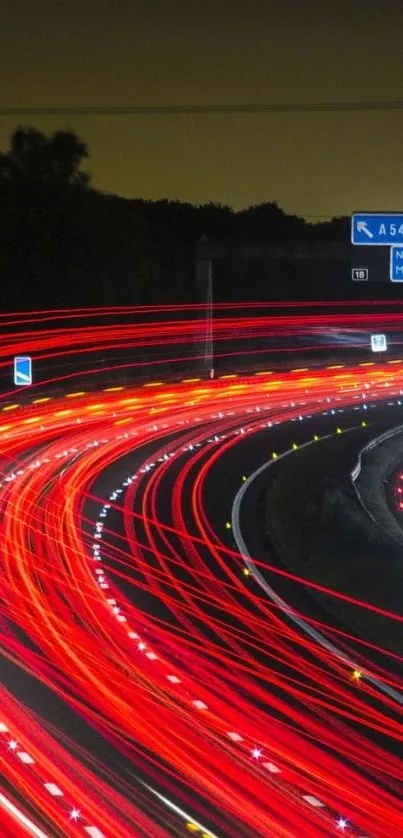 Night highway with vibrant red light trails.