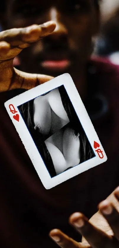 Magical playing card floating between hands.