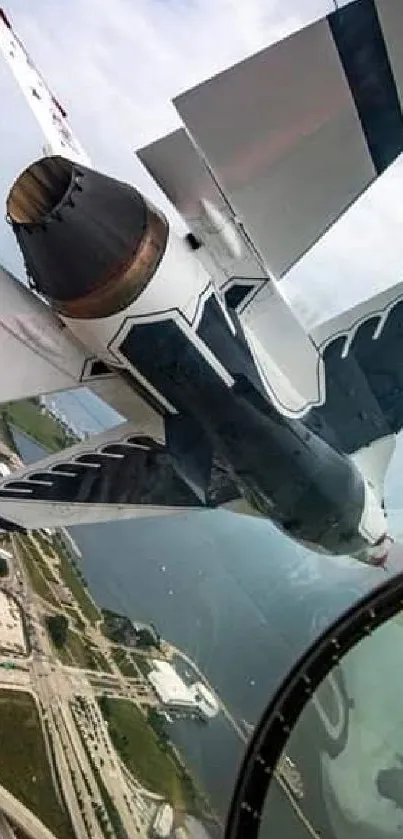 Fighter jet performing aerial maneuvers over scenic landscape.