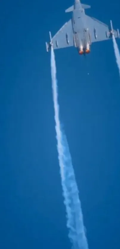 Jet ascends in clear blue sky with vapor trails