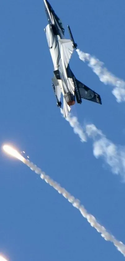 Jet silhouette against vibrant blue sky with striking exhaust trails.