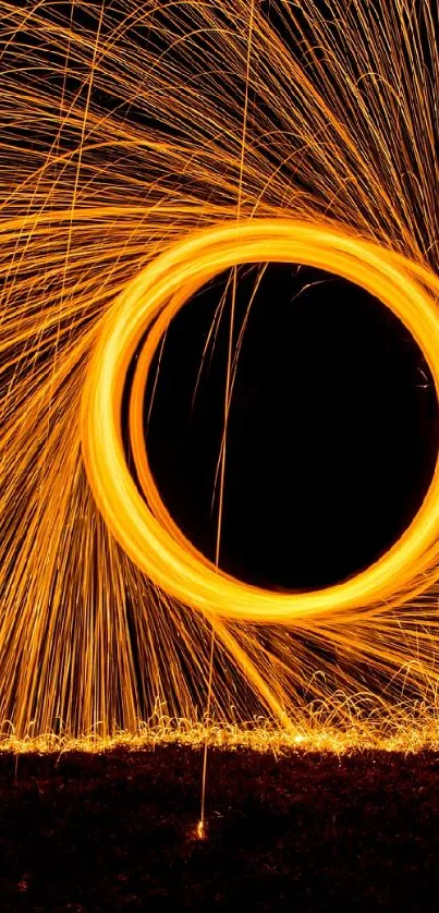 Dynamic light spiral with glowing orange sparks on black background.