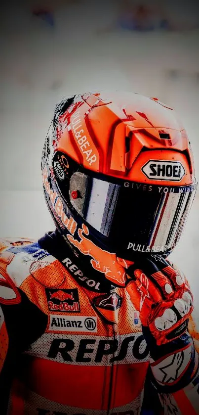 Motorcycle racer in vibrant orange gear.