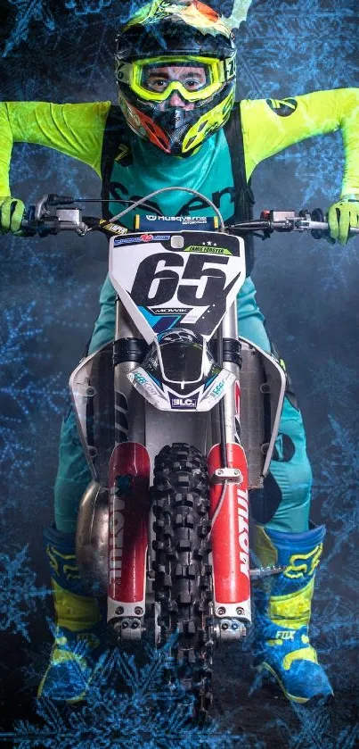 Motocross rider in vibrant gear on motorcycle against a snowy backdrop.