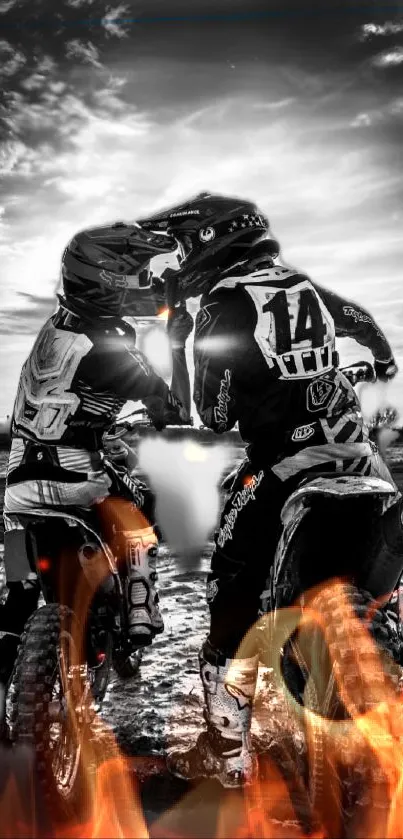 Two motocross riders with fiery effects against a dramatic cloudy sky.