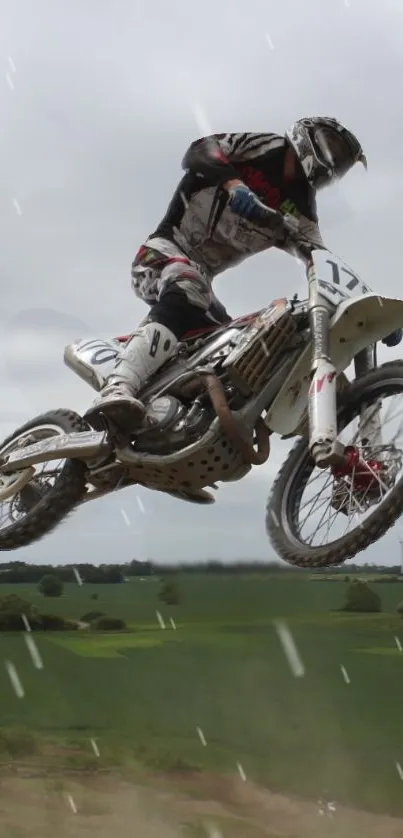 Motocross rider performs a high jump.