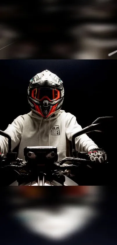 Motorbike rider in helmet and white hoodie against a black backdrop.