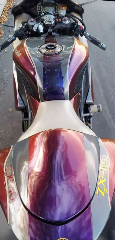 Top view of a sleek motorcycle with vibrant colors on the road.