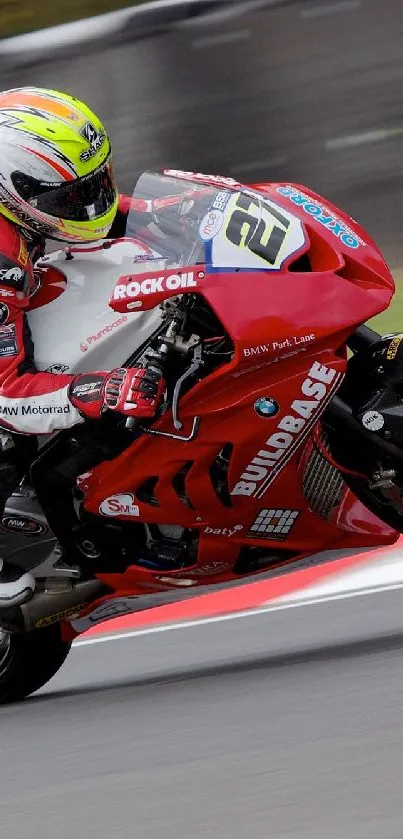 High-speed red motorcycle racing on track with rider.