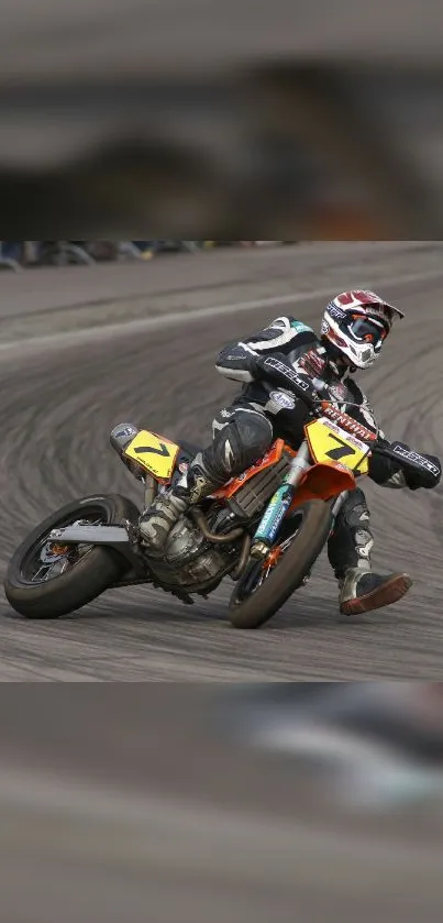 Motorcycle racer leaning into a sharp curve on track.