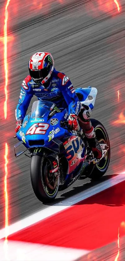 Motorcyclist racing swiftly on a track in vibrant blue gear.