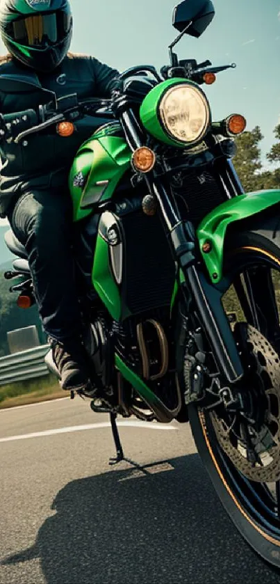 Green motorcycle on open road with rider and scenic background.