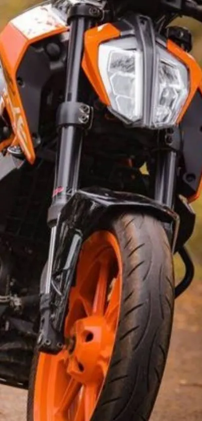 Dynamic motorcycle in vibrant orange and black design on road.