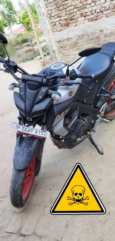 Sleek motorcycle on rustic ground with caution sign.