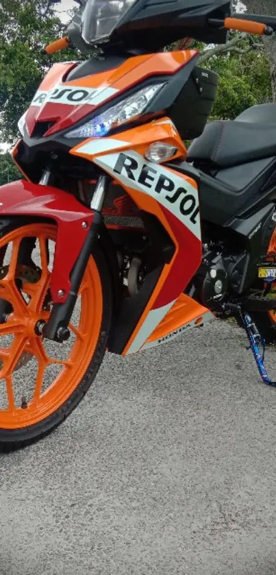 Vibrant orange motorcycle on display outside.