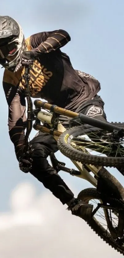 A mountain biker performs a thrilling mid-air stunt under a clear blue sky.