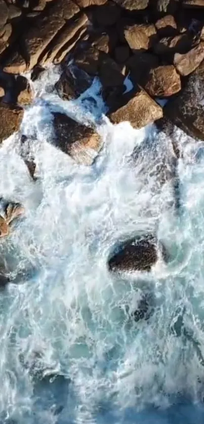 Aerial view of ocean waves crashing on rocky shore.