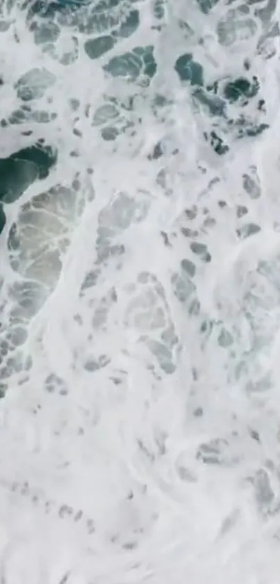 Aerial view of ocean waves with white foamy textures.